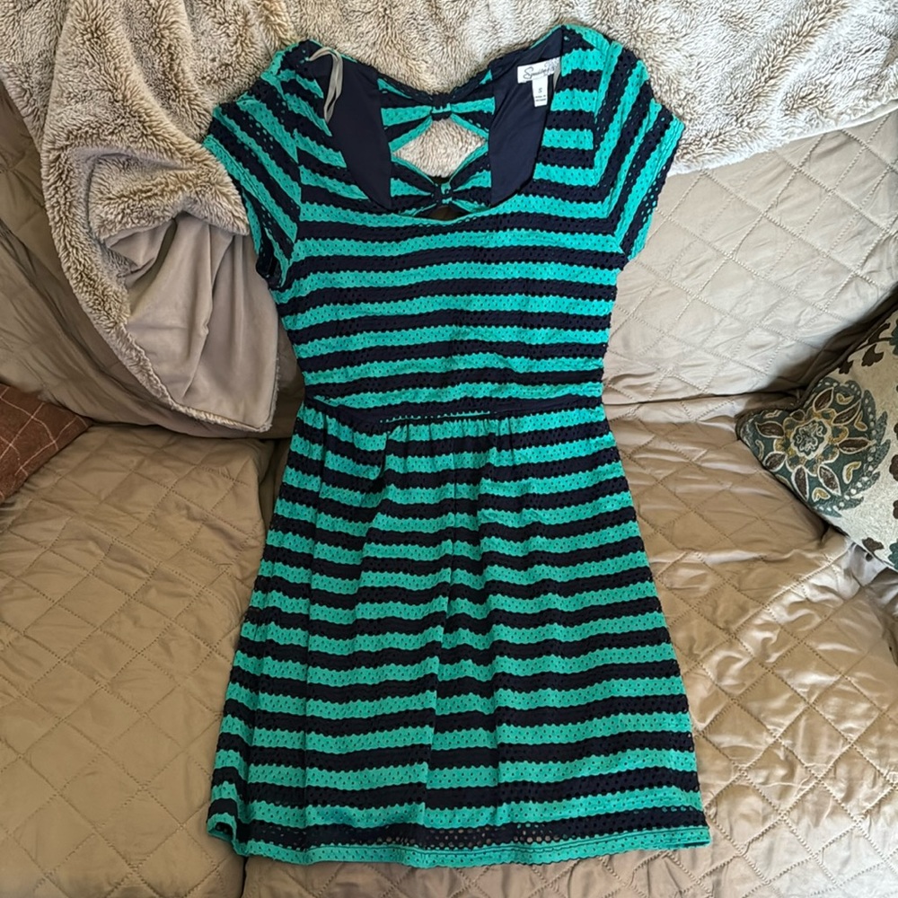 Cute teal and navy blue short sleeve dress with two bows on the back